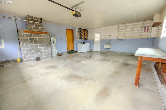745 N 8th St, Lakeside, OR 97449 - garage featuring a garage door opener, washer and dryer, strapped water heater, and a sink