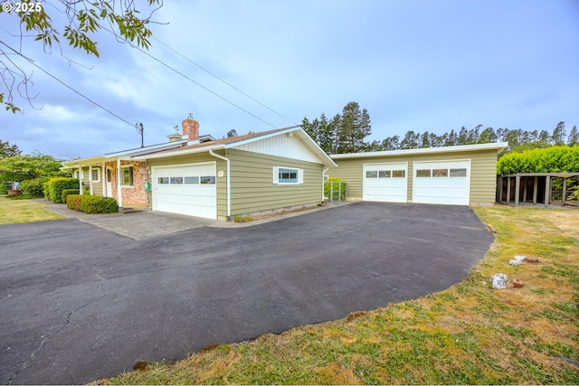 745 N 8th St, Lakeside, OR 97449 - view of side of property featuring a chimney, a garage, and an outdoor structure