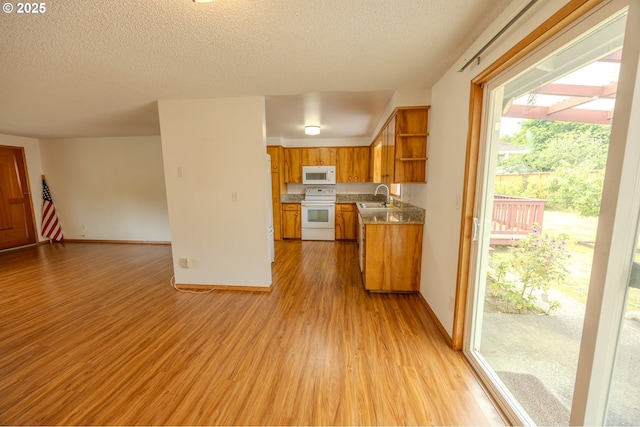 745 N 8th St, Lakeside, OR 97449 - kitchen featuring white appliances, a sink, open shelves, light wood finished floors, and open floor plan