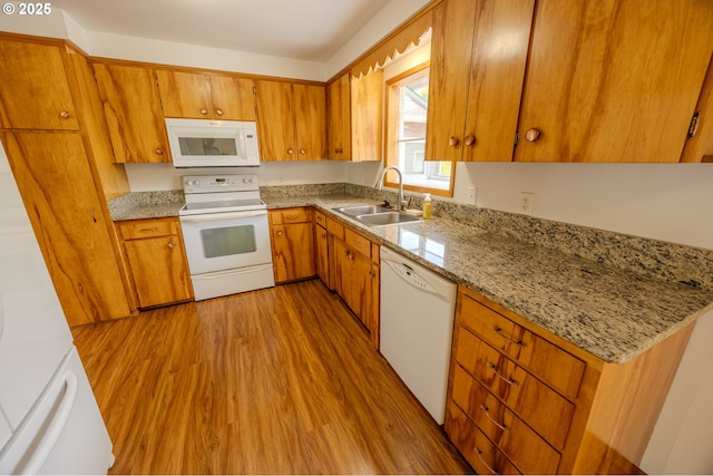 745 N 8th St, Lakeside, OR 97449 - kitchen featuring white appliances, a sink, wood finished floors, and brown cabinetry