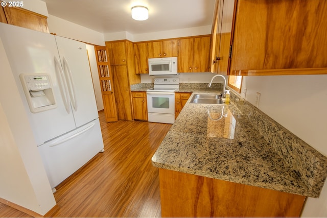 745 N 8th St, Lakeside, OR 97449 - kitchen featuring white appliances, a sink, brown cabinets, light wood-style floors, and light stone counters