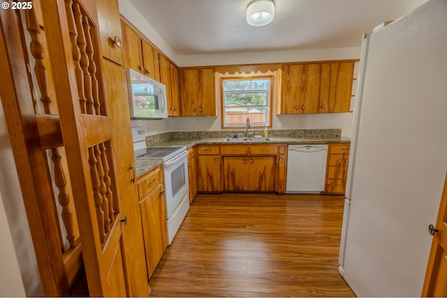 745 N 8th St, Lakeside, OR 97449 - kitchen featuring white appliances, a sink, wood finished floors, and brown cabinets