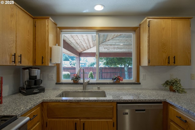 14604 NW 7th Pl, Vancouver, WA 98685 - kitchen with stainless steel dishwasher, backsplash, light stone countertops, and stove