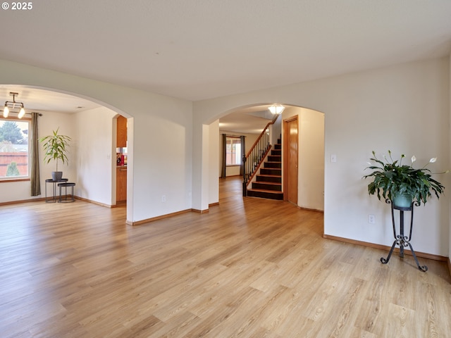 14604 NW 7th Pl, Vancouver, WA 98685 - empty room with light wood finished floors, healthy amount of natural light, stairway, and arched walkways