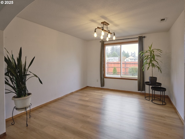 14604 NW 7th Pl, Vancouver, WA 98685 - spare room with light wood-style flooring, arched walkways, and a textured ceiling