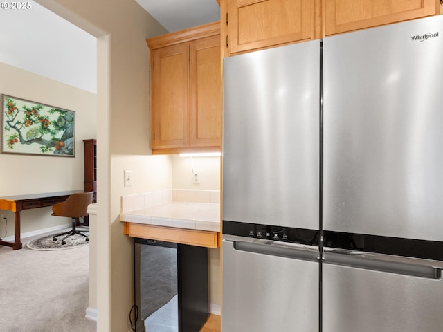 kitchen with light carpet, baseboards, tile counters, and freestanding refrigerator