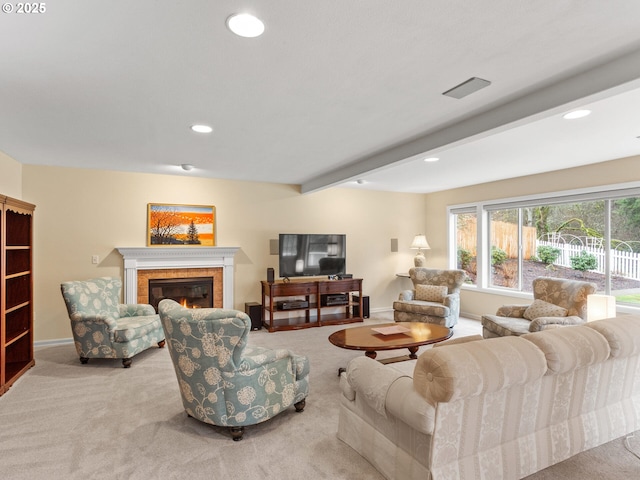 carpeted living area featuring a glass covered fireplace, beam ceiling, baseboards, and recessed lighting