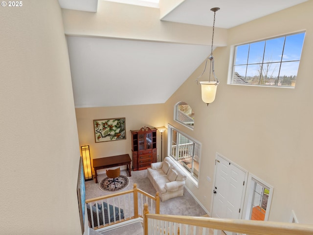 stairs with carpet floors, high vaulted ceiling, and baseboards