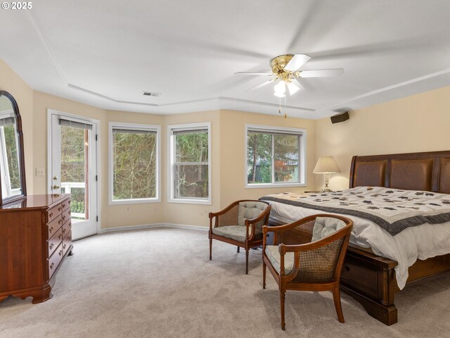 bedroom with access to outside, multiple windows, visible vents, and light colored carpet