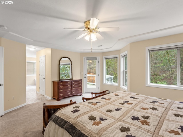 bedroom featuring ceiling fan, light carpet, visible vents, baseboards, and access to outside