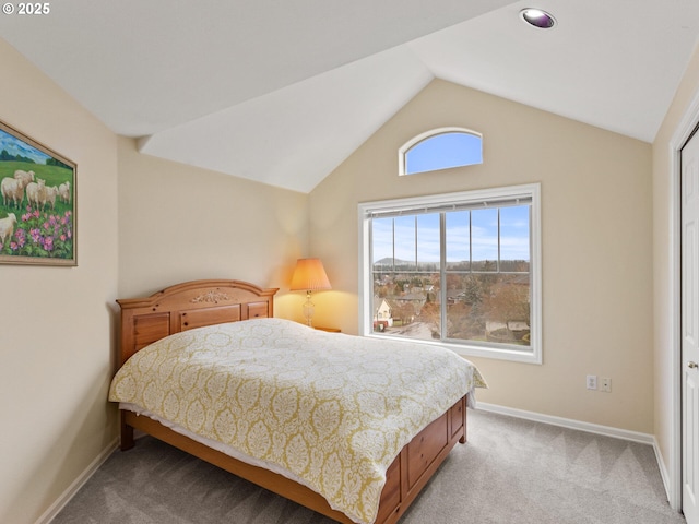 bedroom featuring carpet, baseboards, and vaulted ceiling