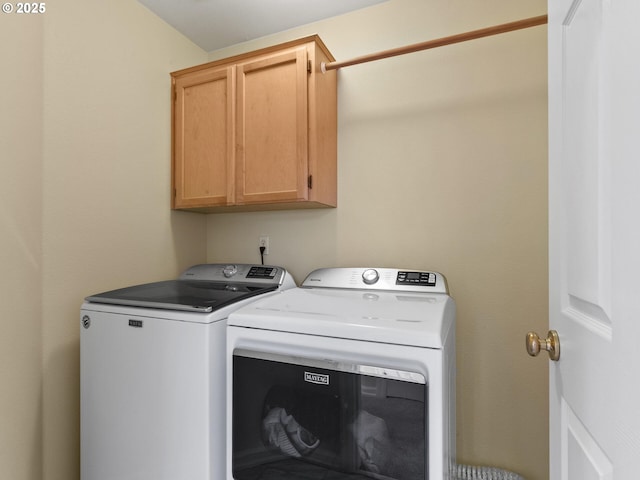 laundry room featuring independent washer and dryer and cabinet space