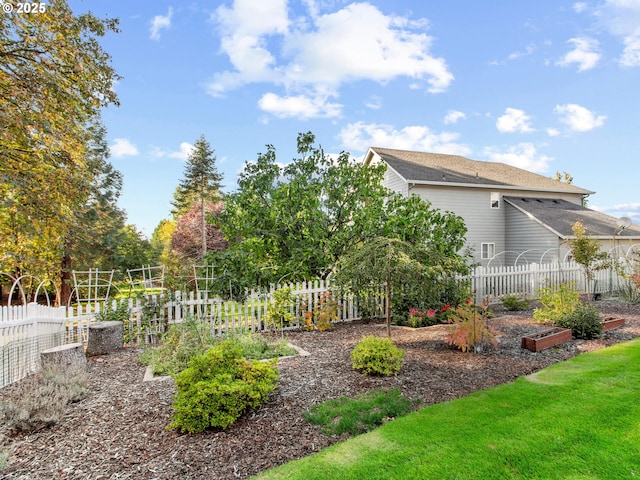 view of yard with a garden and fence