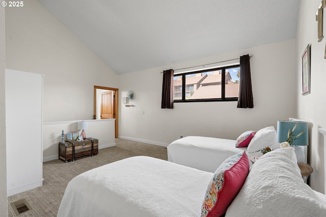 carpeted bedroom with high vaulted ceiling, baseboards, and visible vents