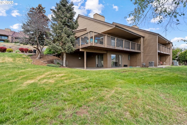 view of yard featuring a patio, central AC unit, and a balcony