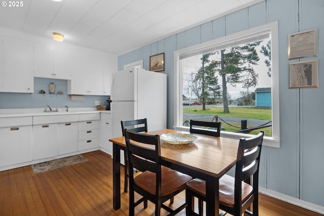 dining area featuring dark wood-style flooring and a wealth of natural light