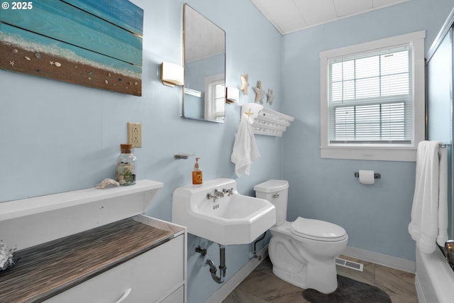 bathroom featuring toilet, baseboards, visible vents, and a sink