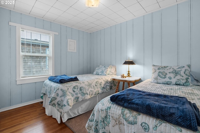 bedroom featuring baseboards and wood finished floors