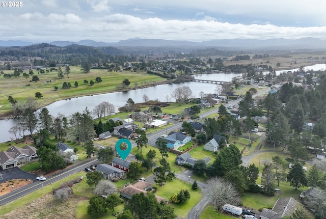 drone / aerial view with a water and mountain view