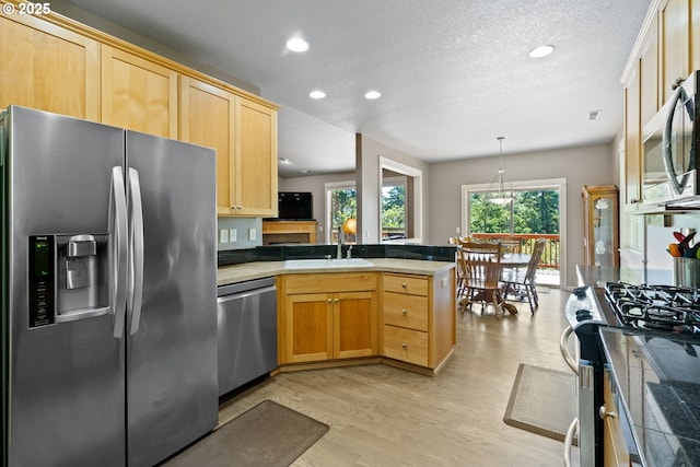 862 NW Edgewood Pl, Albany, OR 97321 - kitchen featuring appliances with stainless steel finishes, a peninsula, light brown cabinets, recessed lighting, and light wood-style flooring