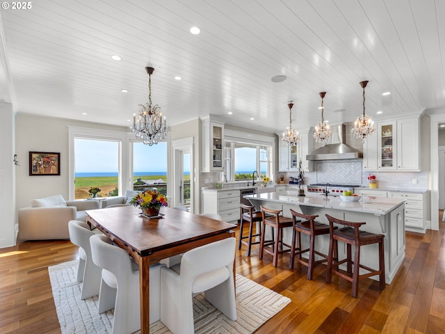 dining space with a chandelier, recessed lighting, wood-type flooring, and wood ceiling