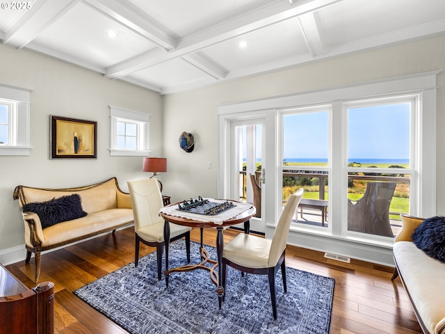 dining space with coffered ceiling, wood-type flooring, beamed ceiling, baseboards, and recessed lighting