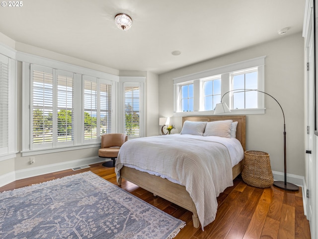 bedroom featuring baseboards and wood finished floors