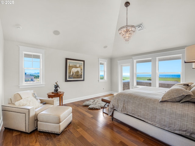 bedroom featuring a chandelier, high vaulted ceiling, wood finished floors, baseboards, and a water view