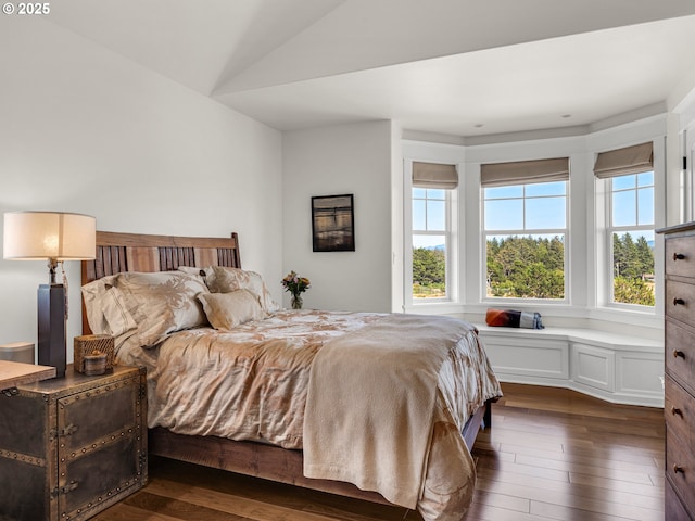 bedroom with dark wood-style flooring and vaulted ceiling