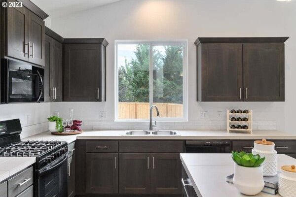 1486 N Millican Creek St, Lafayette, OR 97127 - kitchen with black appliances, plenty of natural light, light countertops, and dark brown cabinets