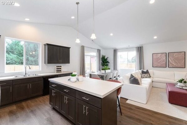 1486 N Millican Creek St, Lafayette, OR 97127 - kitchen featuring lofted ceiling, open floor plan, dark wood-style floors, a center island, and light countertops