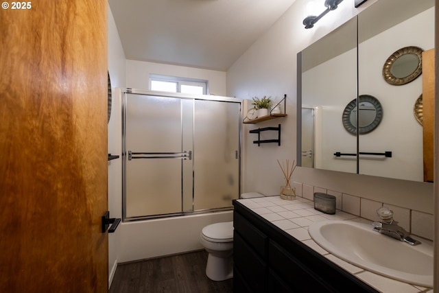 full bathroom featuring toilet, enclosed tub / shower combo, vanity, and hardwood / wood-style flooring