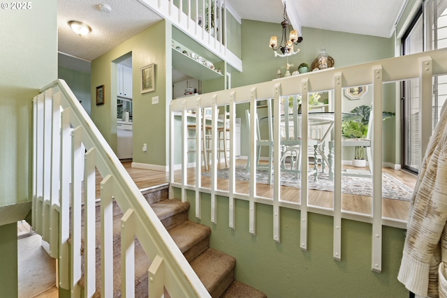 43605 State Highway 38 Unit 22, Reedsport, OR 97467 - stairs featuring a chandelier, lofted ceiling, and a textured ceiling
