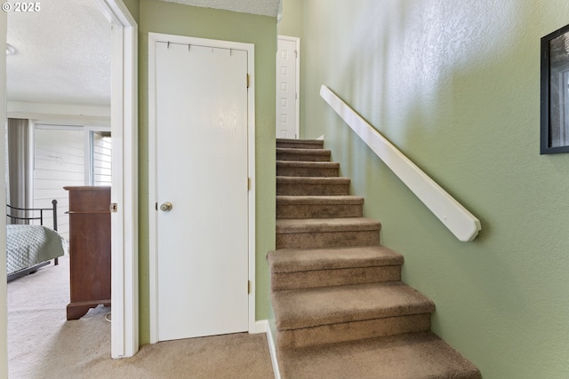 43605 State Highway 38 Unit 22, Reedsport, OR 97467 - stairs featuring carpet flooring and a textured ceiling