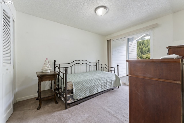 43605 State Highway 38 Unit 22, Reedsport, OR 97467 - bedroom with light carpet, a textured ceiling, and baseboards