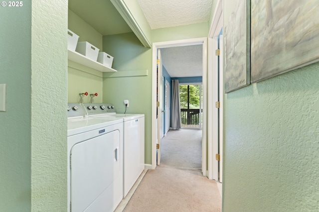 43605 State Highway 38 Unit 22, Reedsport, OR 97467 - laundry area featuring washing machine and clothes dryer, light carpet, a textured ceiling, and a textured wall
