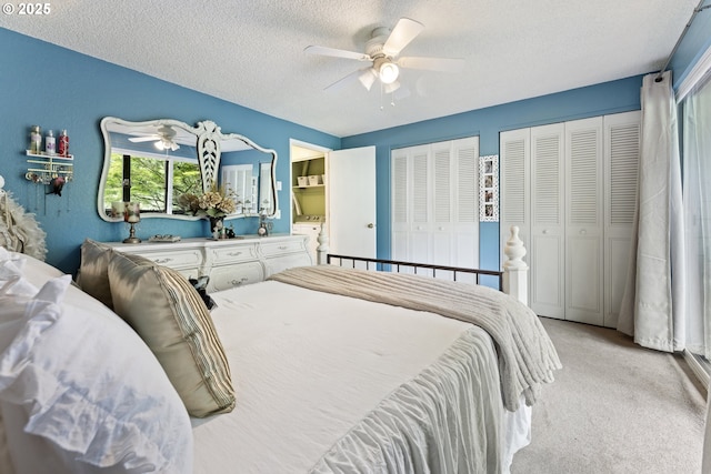 43605 State Highway 38 Unit 22, Reedsport, OR 97467 - bedroom featuring a textured ceiling, light colored carpet, two closets, and ceiling fan