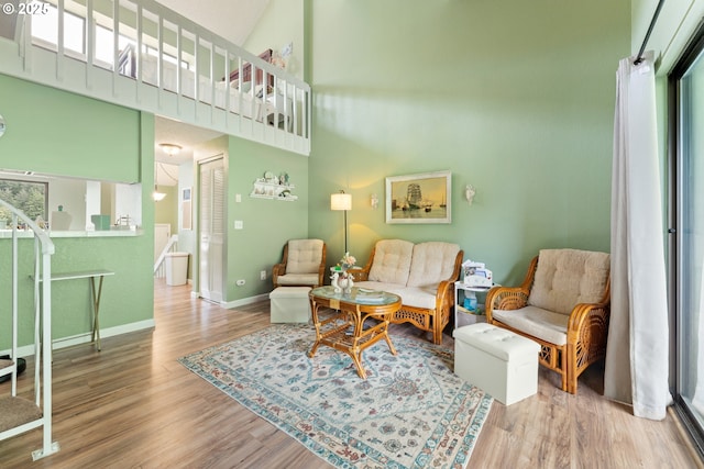 43605 State Highway 38 Unit 22, Reedsport, OR 97467 - living area with wood finished floors, a towering ceiling, and baseboards