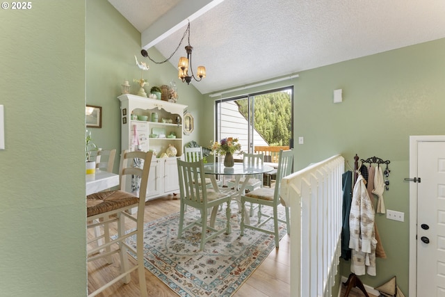 43605 State Highway 38 Unit 22, Reedsport, OR 97467 - dining space with a chandelier, a textured ceiling, and light wood-type flooring