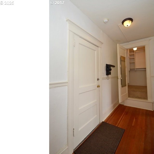 corridor featuring wood finished floors