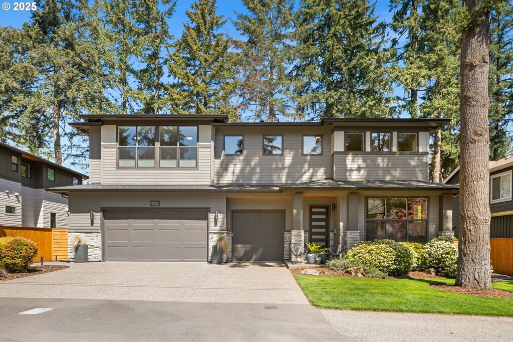 4333 Haven St, Lake Oswego, OR 97035 - view of front of property featuring an attached garage, driveway, fence, and stone siding
