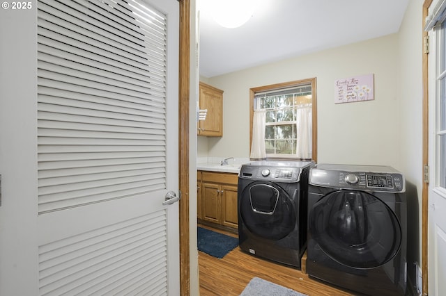 14504 SE Old Barn Ln, Damascus, OR 97089 - washroom with washing machine and clothes dryer, cabinet space, and wood finished floors
