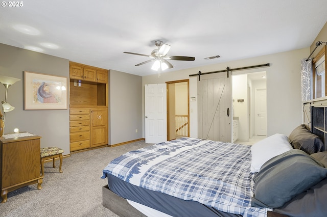 14504 SE Old Barn Ln, Damascus, OR 97089 - bedroom featuring a barn door, light carpet, ceiling fan, and baseboards