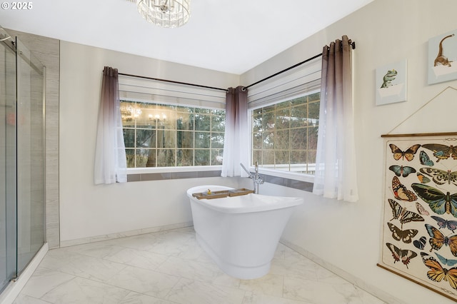 14504 SE Old Barn Ln, Damascus, OR 97089 - full bathroom featuring marble look tiles, a shower stall, baseboards, and a freestanding tub