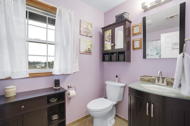 14504 SE Old Barn Ln, Damascus, OR 97089 - full bathroom with vanity, toilet, backsplash, baseboards, and tile patterned flooring