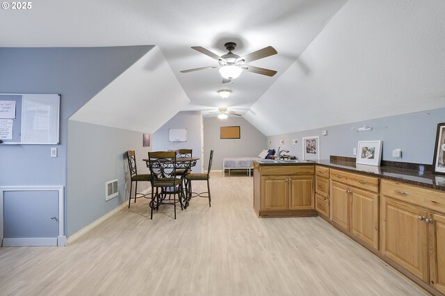 14504 SE Old Barn Ln, Damascus, OR 97089 - kitchen with light wood-type flooring, a ceiling fan, vaulted ceiling, a peninsula, and baseboards