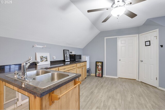 14504 SE Old Barn Ln, Damascus, OR 97089 - kitchen with a sink, a breakfast bar, a peninsula, dark countertops, and stainless steel microwave