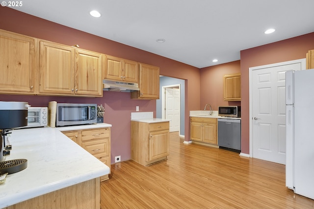 14504 SE Old Barn Ln, Damascus, OR 97089 - kitchen featuring stainless steel appliances, under cabinet range hood, light brown cabinetry, light wood-type flooring, and light countertops