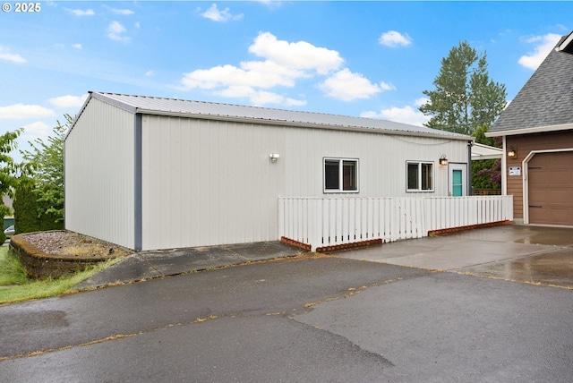 14504 SE Old Barn Ln, Damascus, OR 97089 - view of property exterior with a garage, metal roof, and driveway