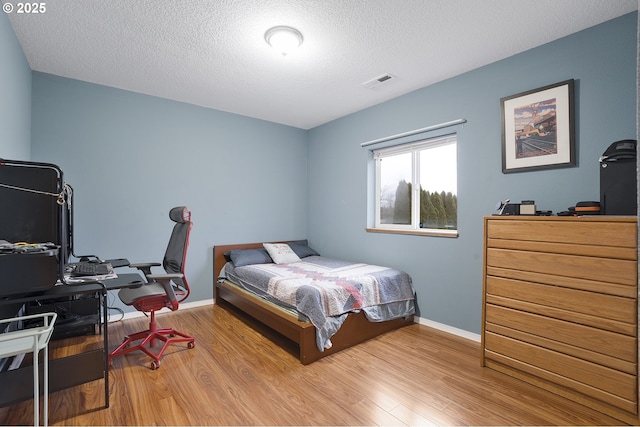 14504 SE Old Barn Ln, Damascus, OR 97089 - bedroom featuring wood finished floors, a textured ceiling, and baseboards